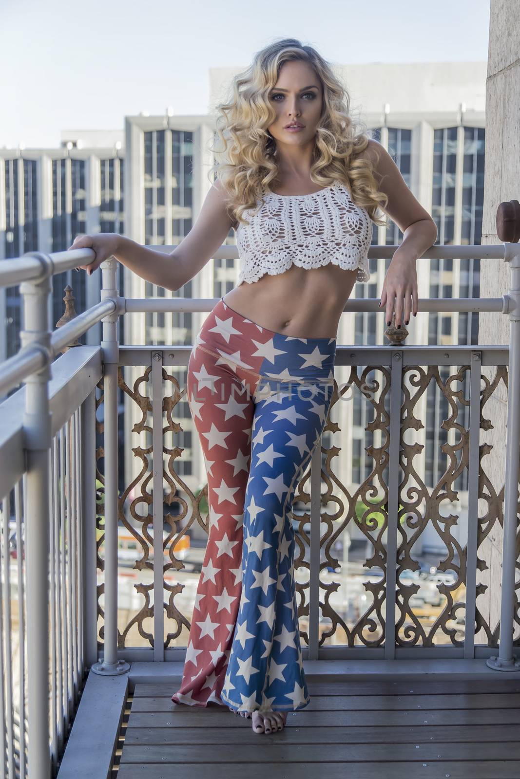 A blonde model posing in an outdoor environment wearing vintage clothing