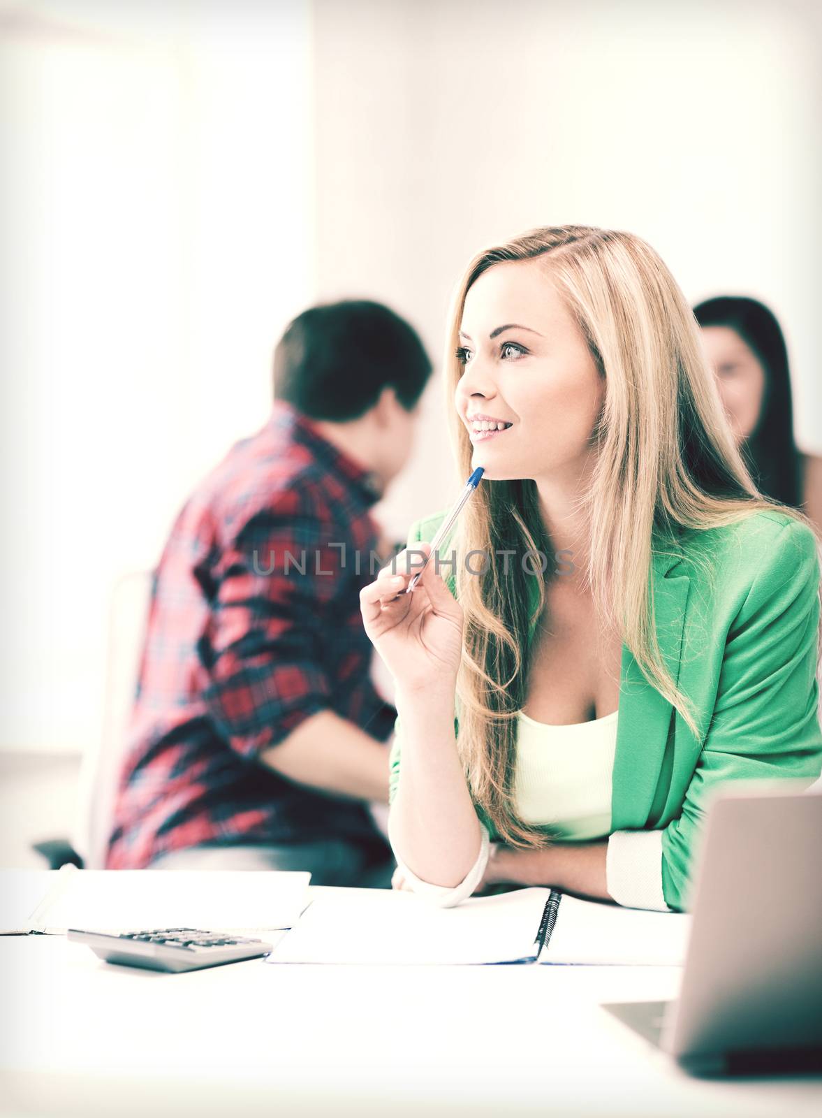 education concept - student girl with notebook and calculator in college