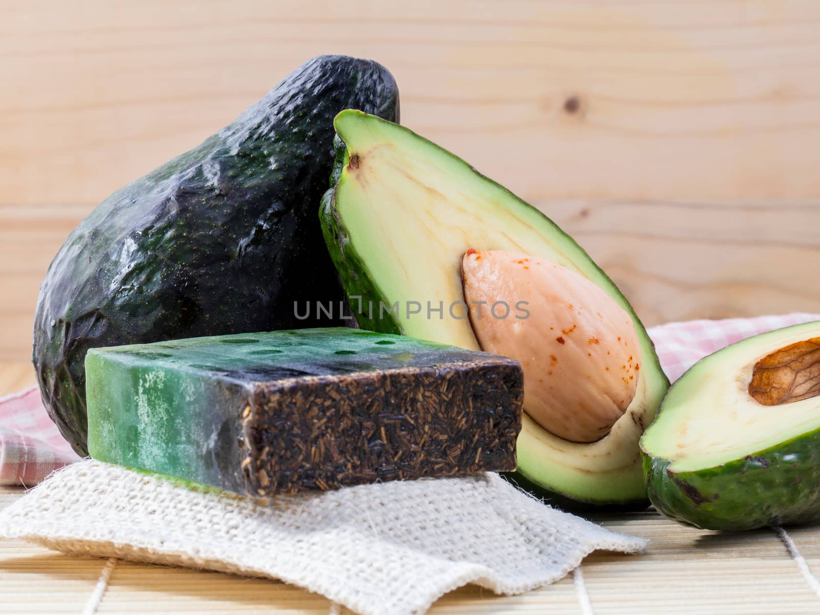 Alternative skin care  and scrub fresh  avocado  and  avocado soap on wooden background.
