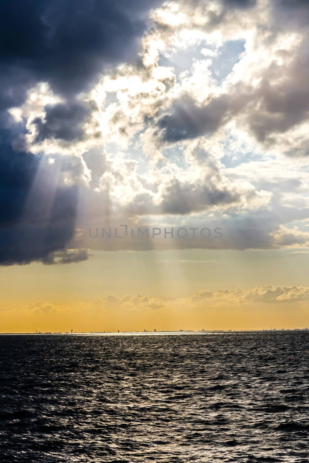 Sun beams through stormy clouds over Baltic Sea in Malmo, Sweden.