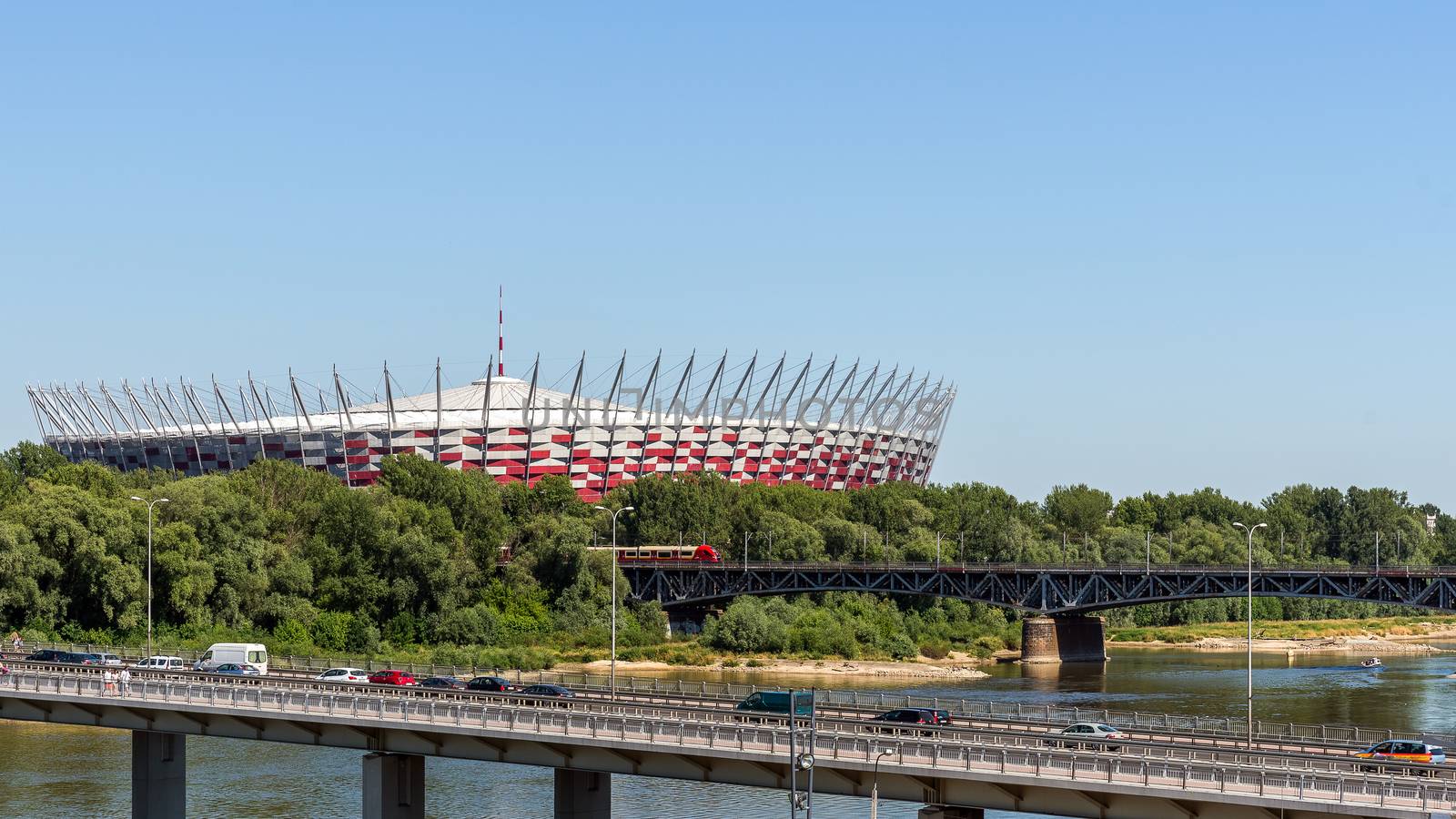 The Polish National Stadium in Warsaw preceded by the bridges over Vistula river. Designed and constructed for UEFA EURO 2012 tournament co-hosted by Poland and Ukraine.