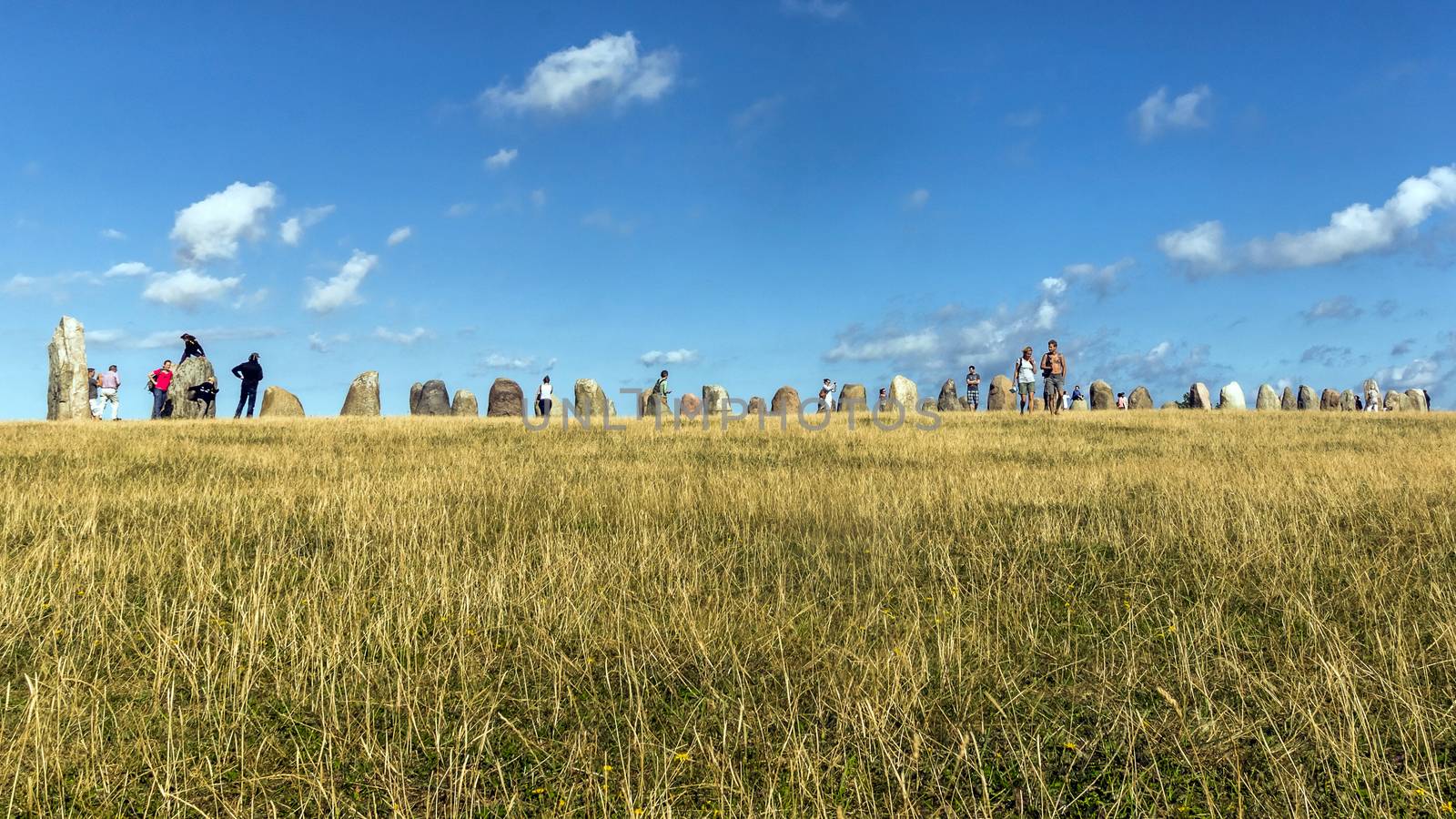 Tourists visit area of Ales Stenar near Kaseberga, mysterious circle created 1400 years ago. The circle consists of 59 large stones forming a circle resembling a ship shape.
