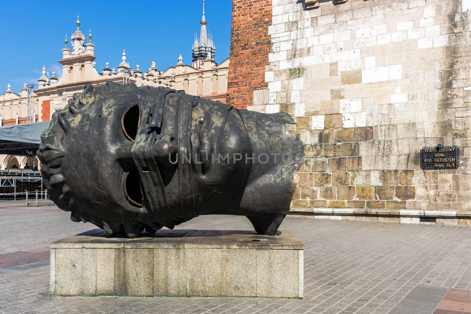 Interesting and ambiguous sculpture "Eros bendato" by Polish artist Igor Mitoraj (1944 – 2014),  in the historical Old Market Square in Krakow, Poland.