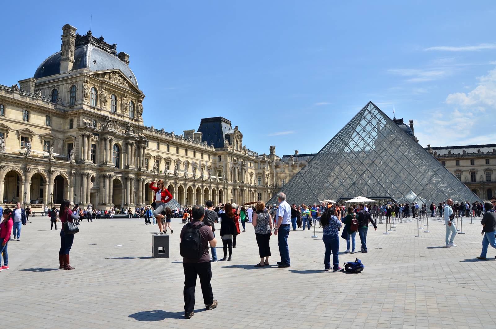Paris, France - May 13, 2015: Tourist visit Louvre museum on May 13, 2015 in Paris. This is one of the most popular tourist destinations in France.