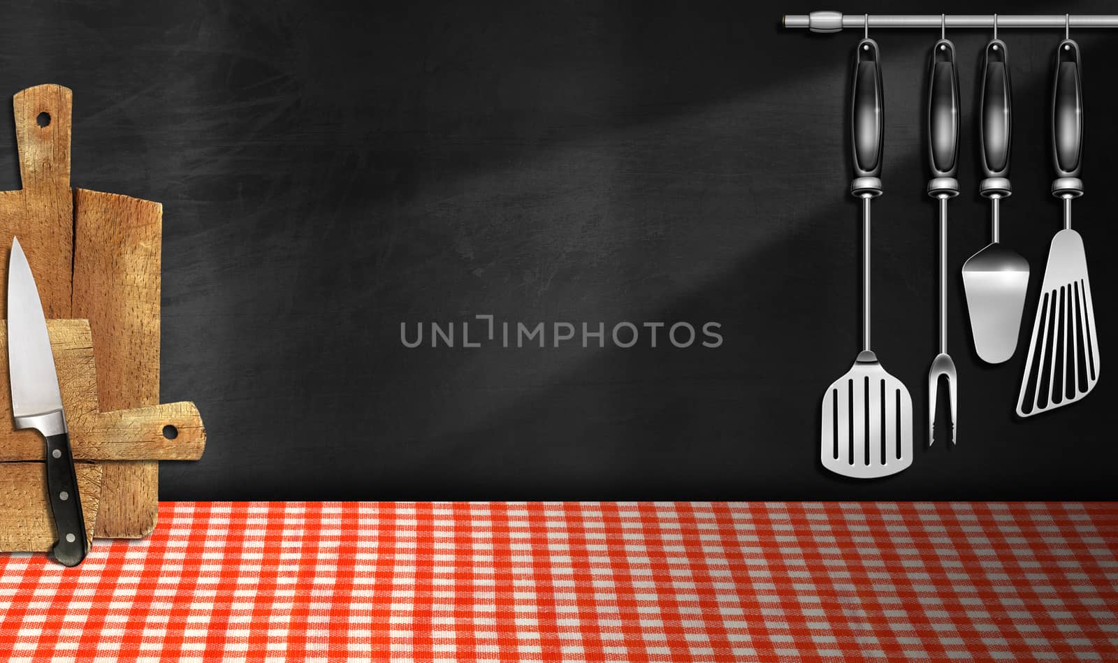 Empty blackboard on the wall, cutting boards, kitchen utensils and knife, table with a checkered tablecloth. Template for recipes or food menu