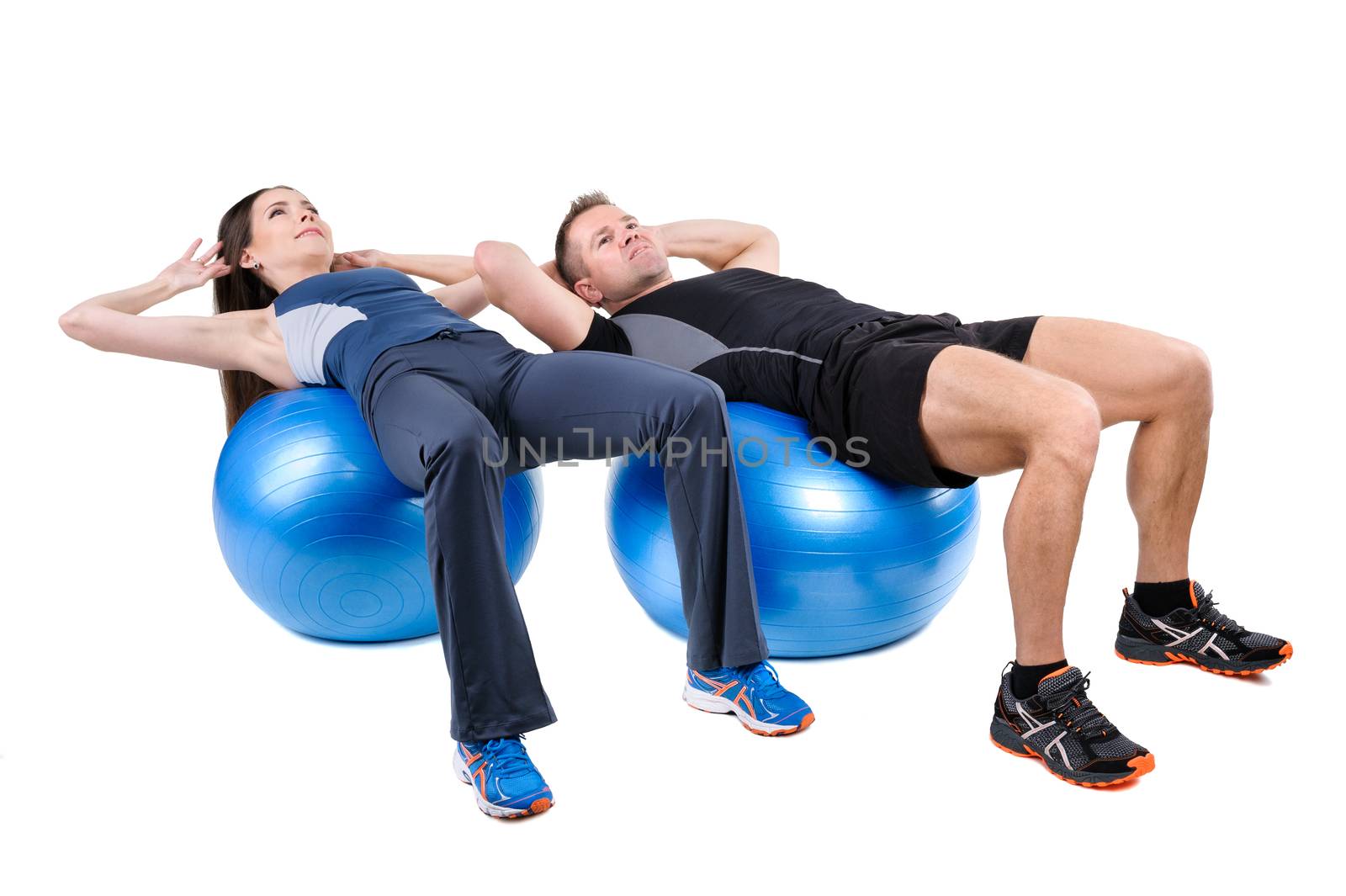 Young couple shows starting position of Abdominal Fitball Workout, isolated on white