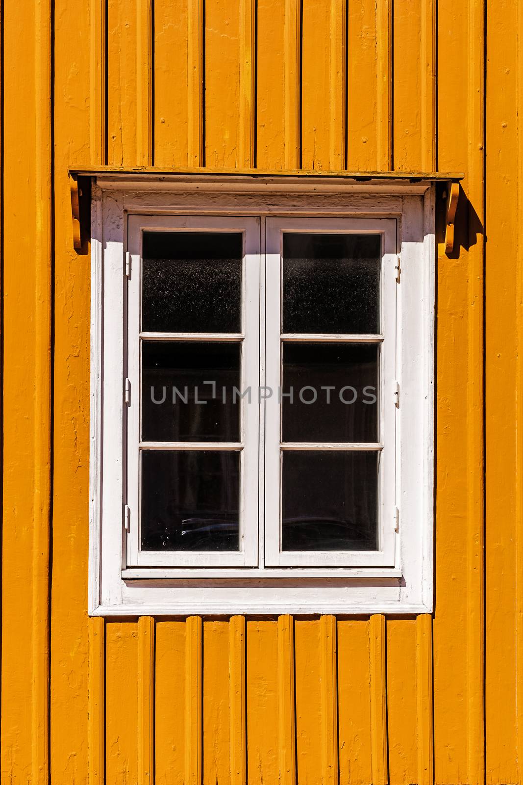 Window on a wooden facade, exapmle of typical Swedish traditional architecture.