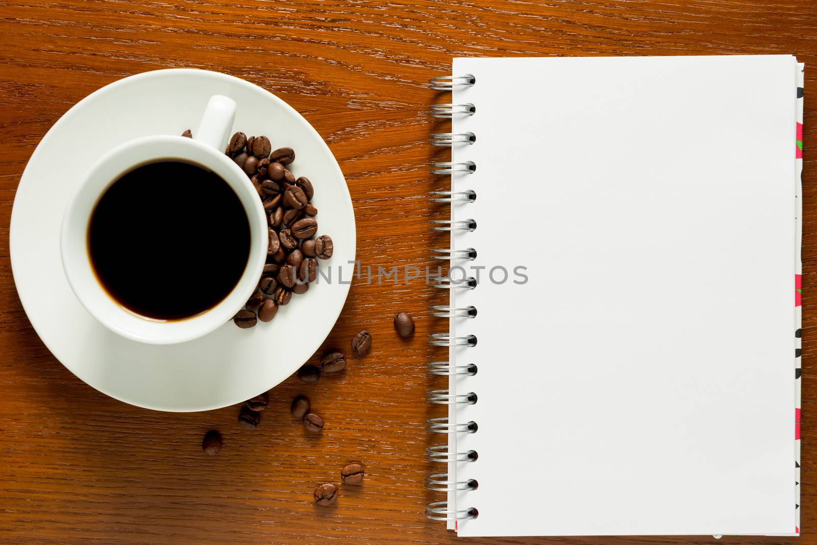 note pad and a cup of coffee with roasted grains