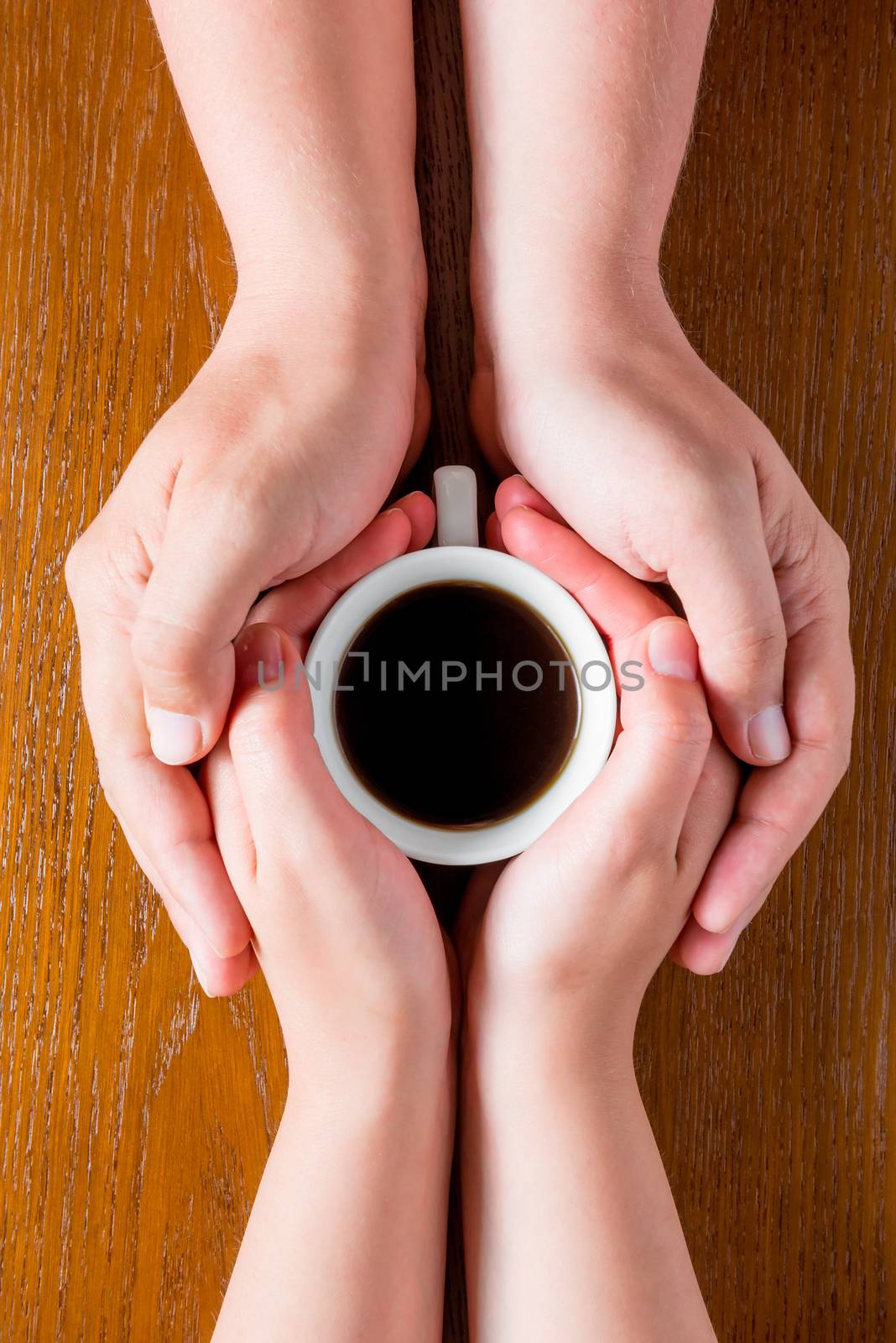Hands loving couple and a cup of hot coffee top view