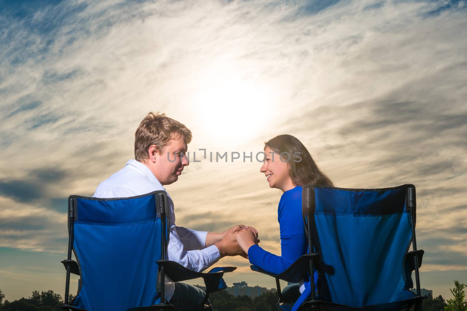 married couple sitting in chairs at dawn