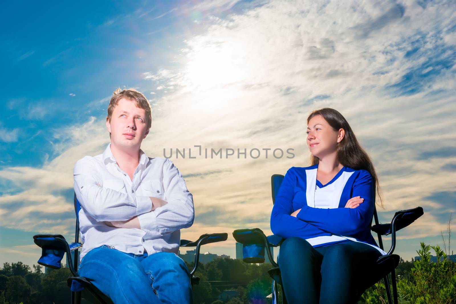 portrait of men and women 30 years of sitting in a chair outdoor by kosmsos111
