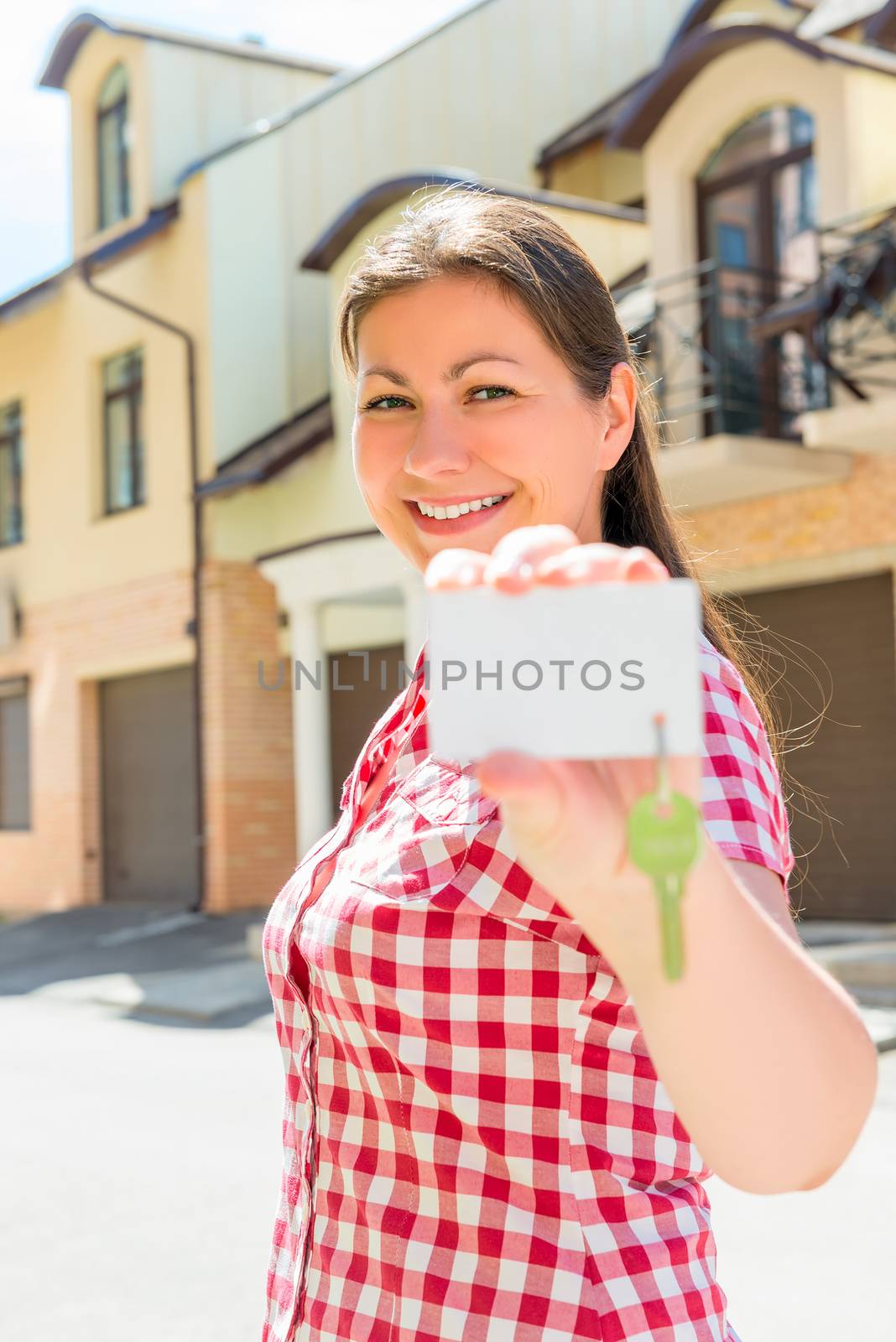 Vertical portrait of a happy lady with a key of new house by kosmsos111