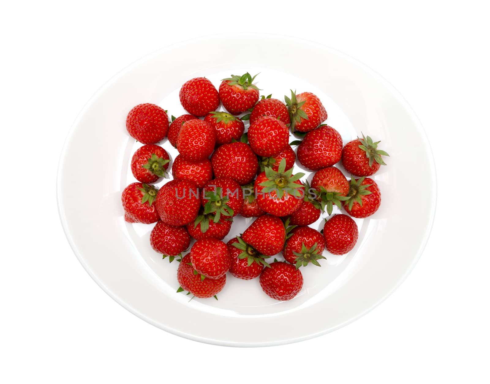 fresh garden strawberries on a white plate, top view