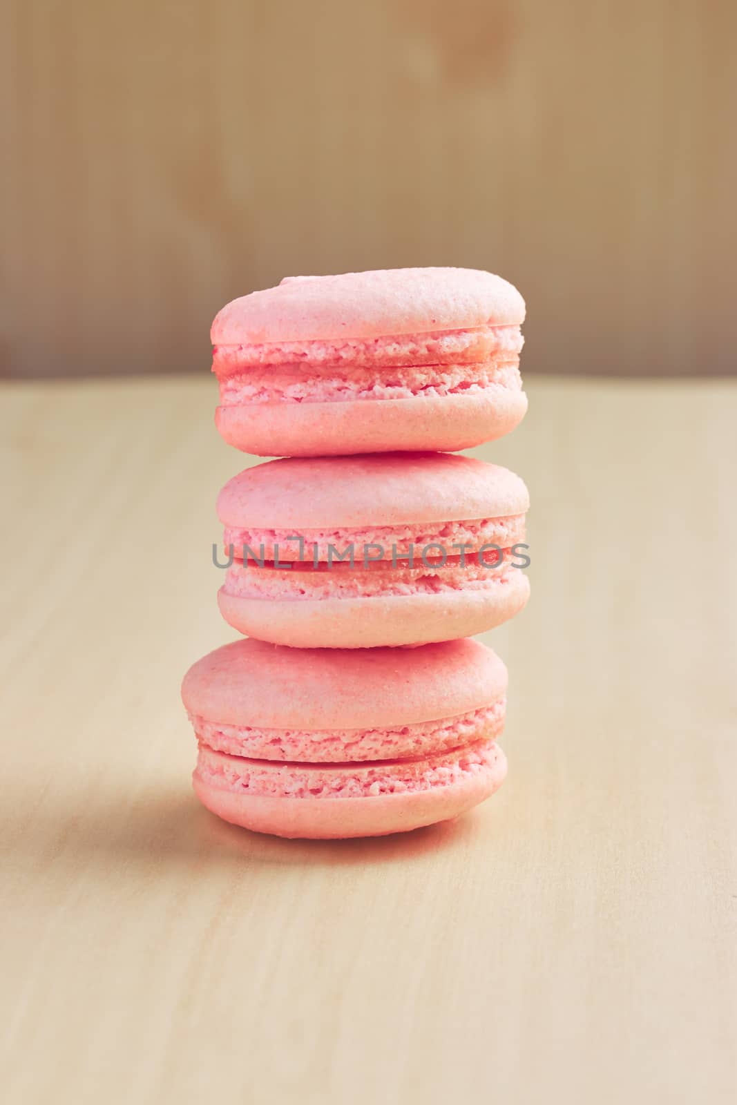 Sweet french macaroons on wooden background