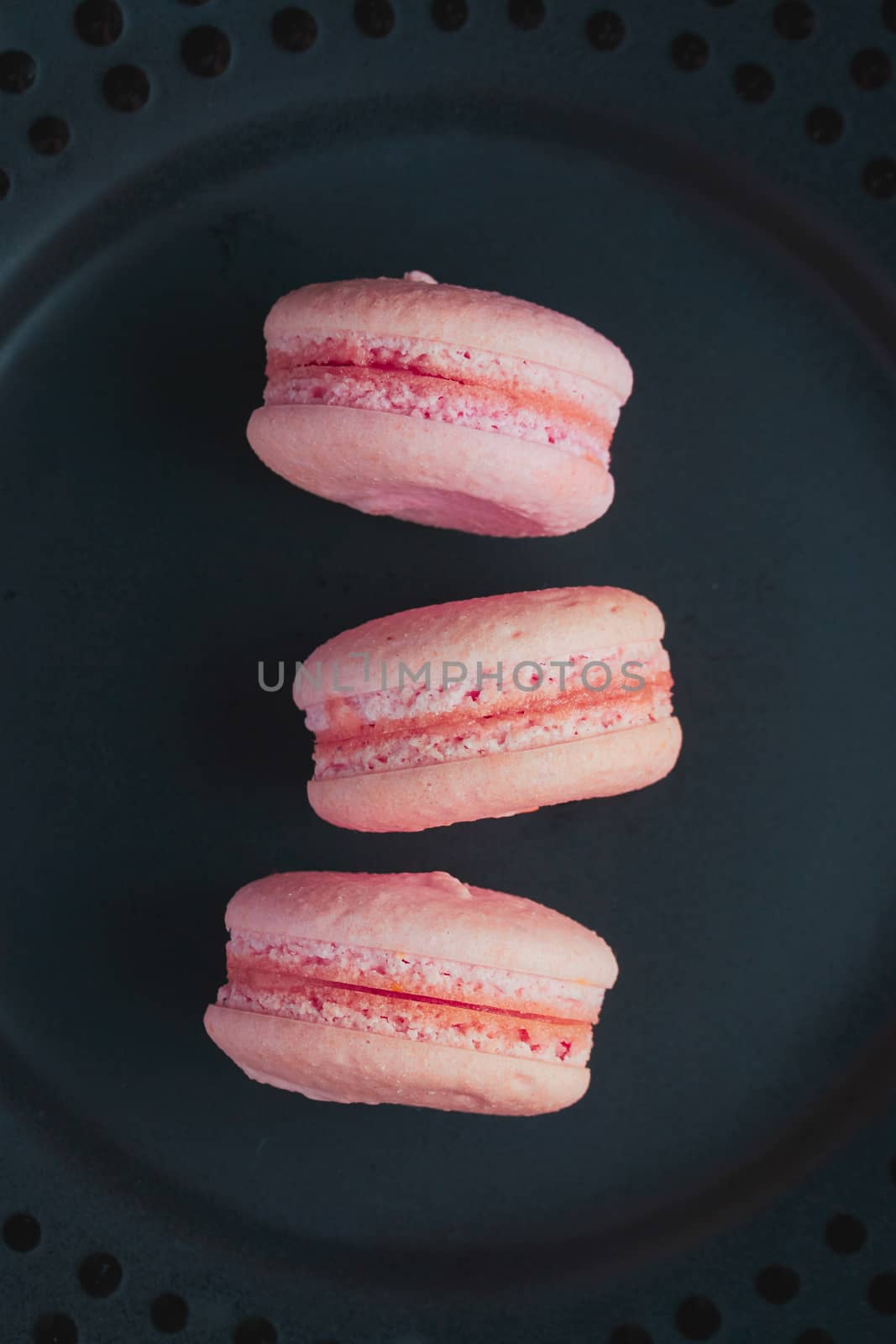 Sweet french macaroons on dark  background