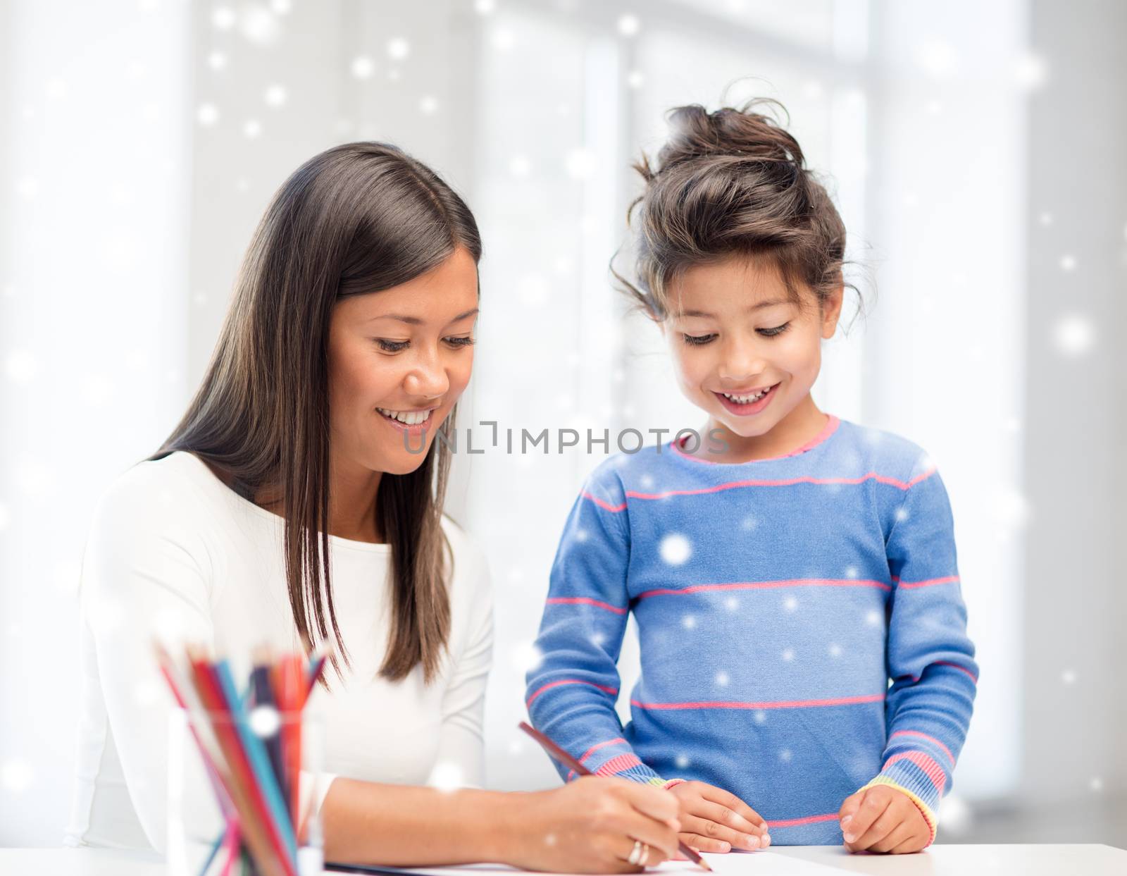 mother and daughter with coloring pencils indoors by dolgachov