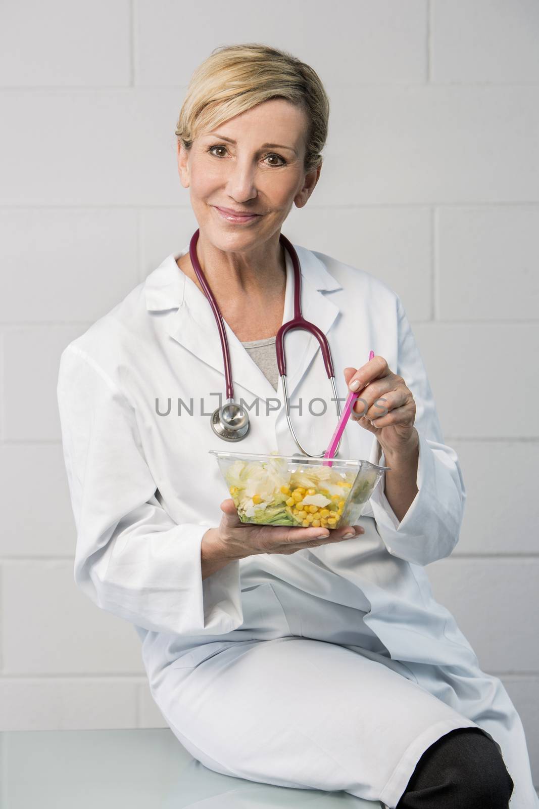 woman doctor having lunch break by Flareimage