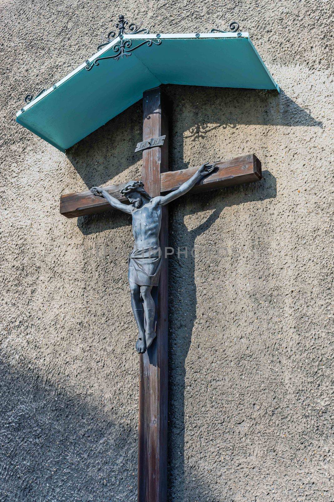 Statue of Jesus Christ crucified on the wall of the St. Peter and Paul church, in Tarnowskie Gory, Silesia region, Poland.