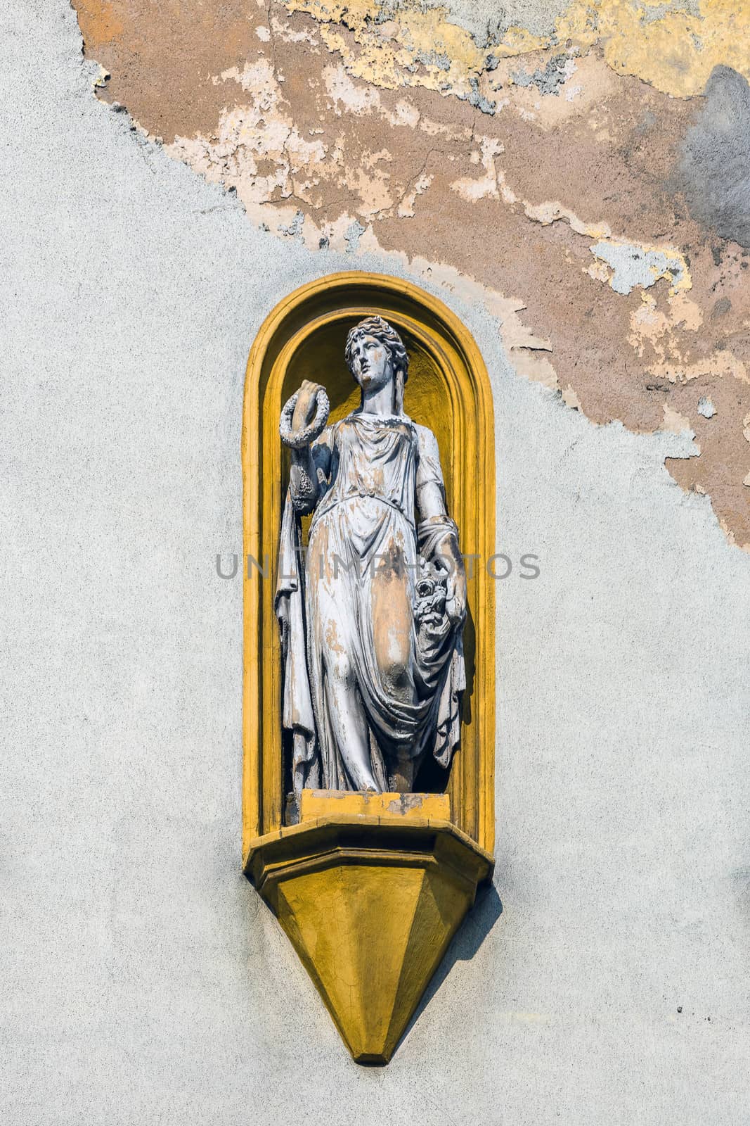Allegorical statue on the facade of the tenement in Tarnowskie Gory, Silesia region, Poland.