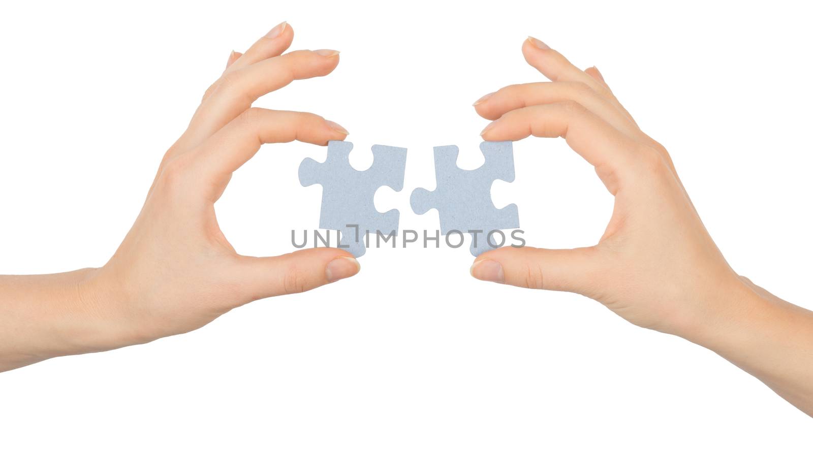 Hands holding puzzle pieces on isolated white background