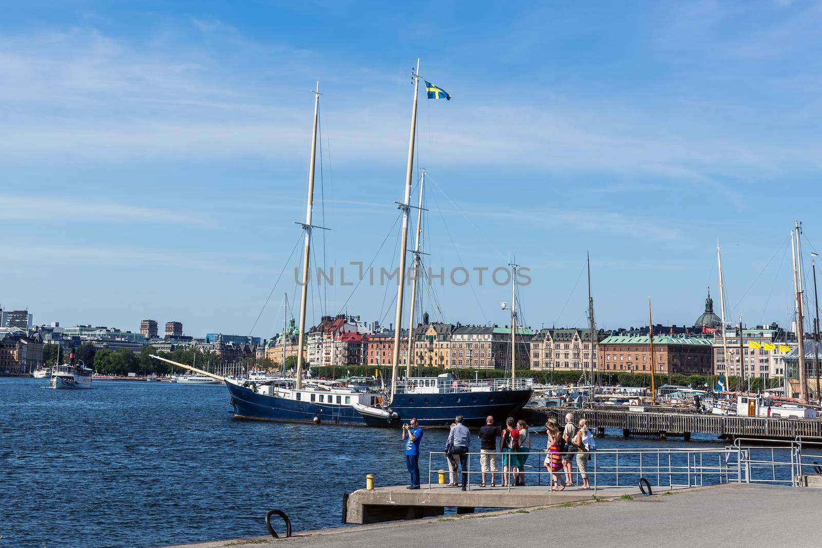 Passengers wait for a ferry in front of the Vasa Museum on the Djurgarden island in Stockholm. In the background Strandvagen boulevard, the most prestigious avenue in town.