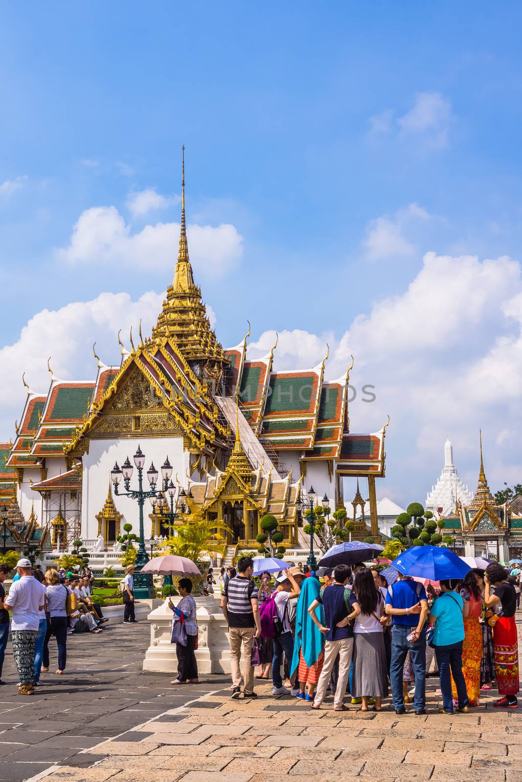 Tourists in the area of The Grand Palace in Bangkok, historical seat of Kings of Siam, main tourist attraction of the city, still used for official events.