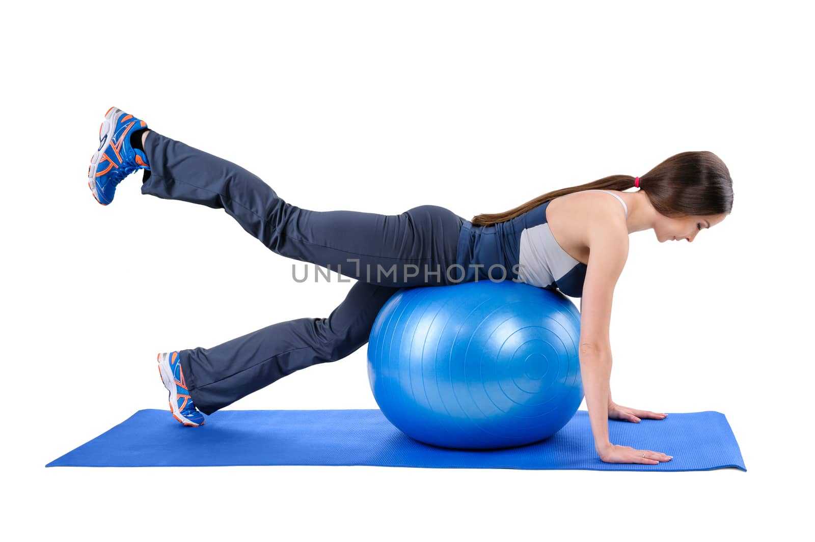Young woman shows starting position of Fitness Stability Ball Glute Kickback Workout, isolated on white