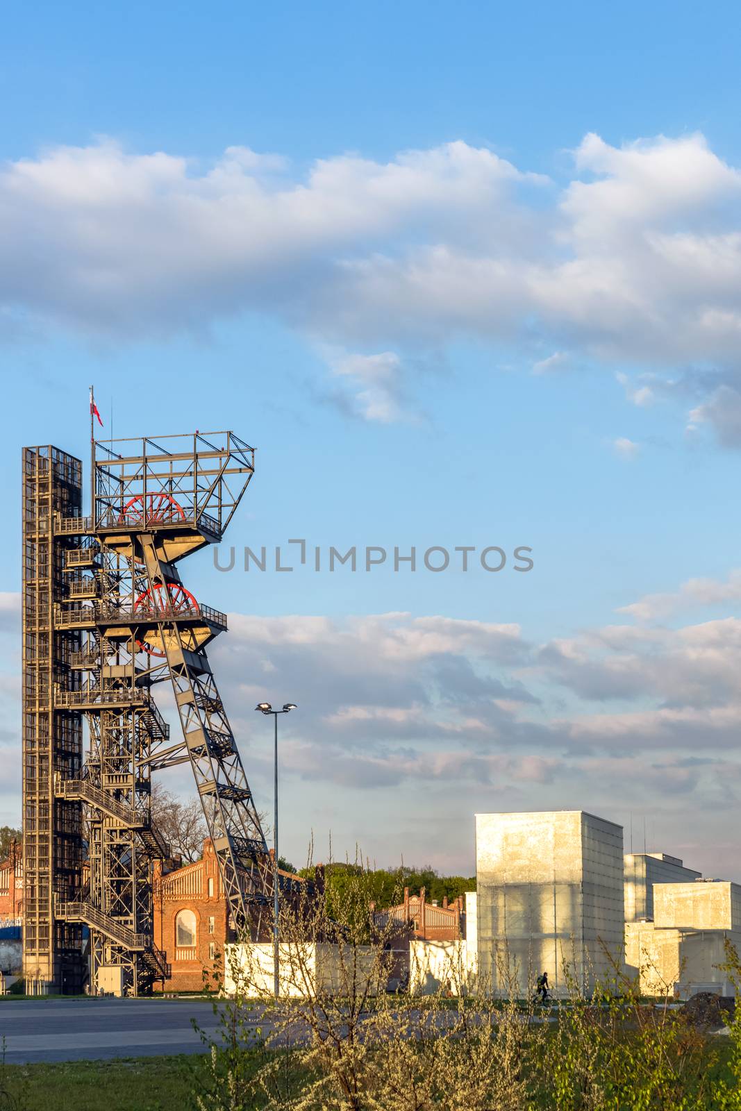 The former coal mine, seat of the Silesian Museum in Katowice at dusk. The complex combines old mining buildings and infrastructure with modern architecture.