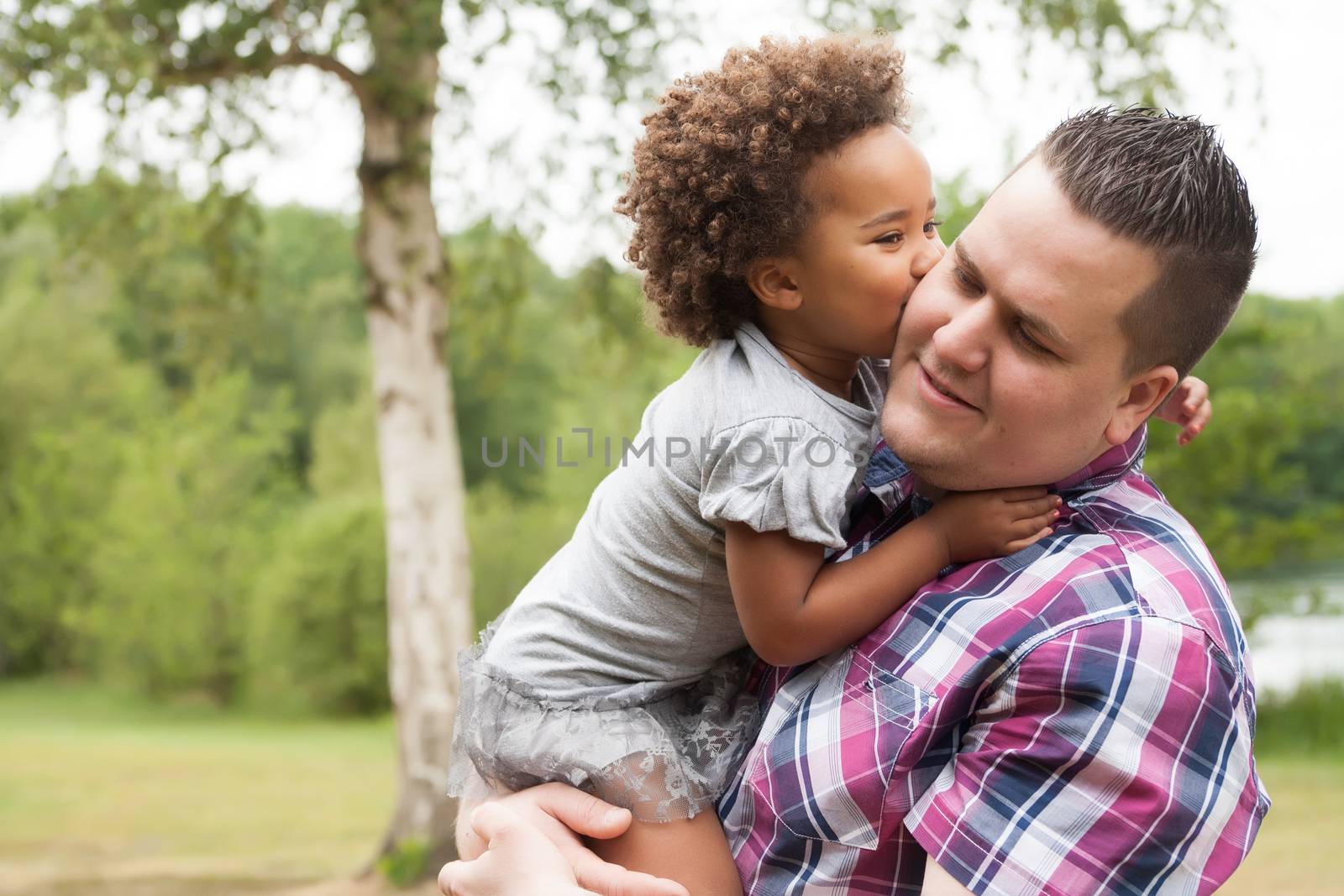 Blank father with his african daugther having a nice time