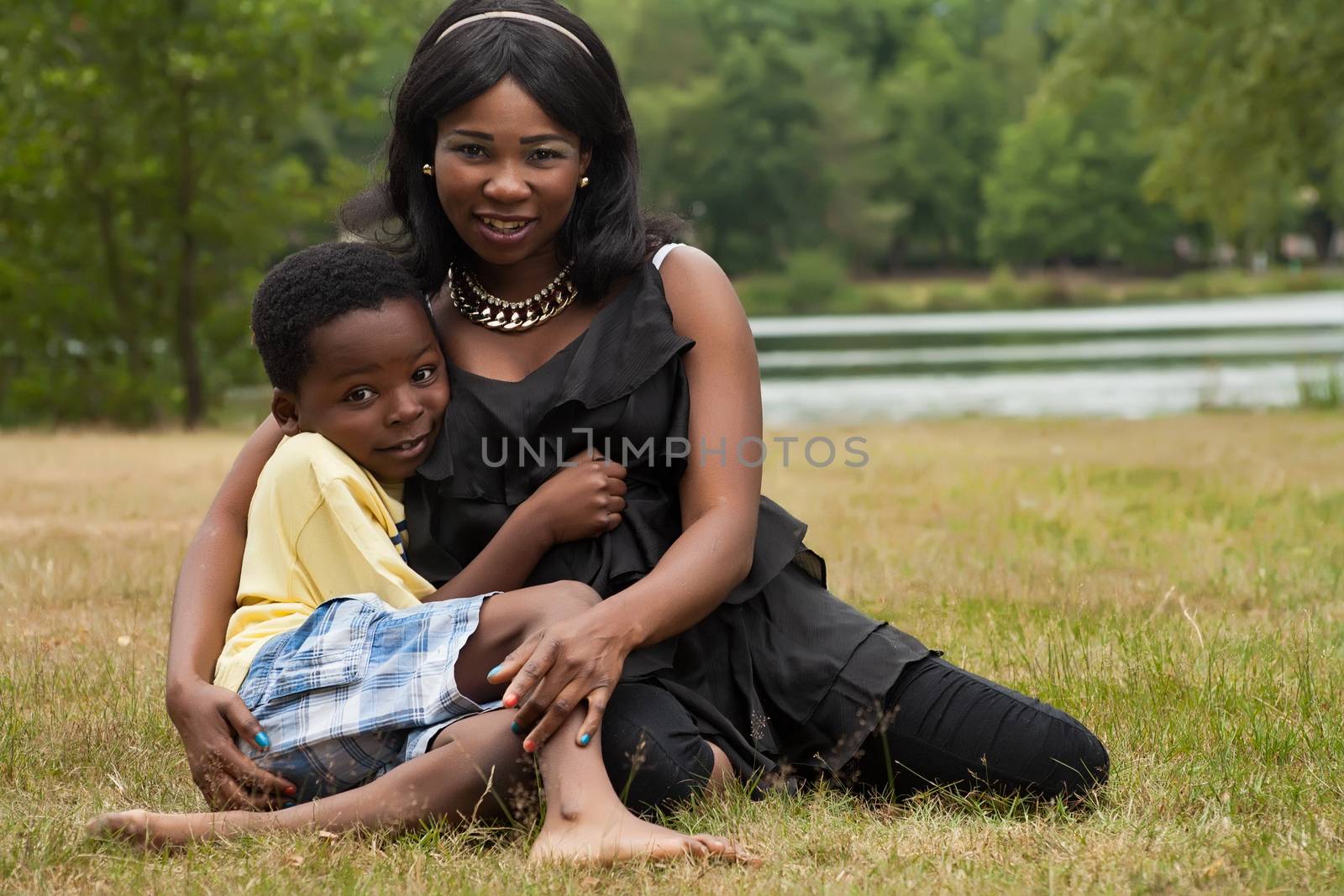 African mother with her son in the grass