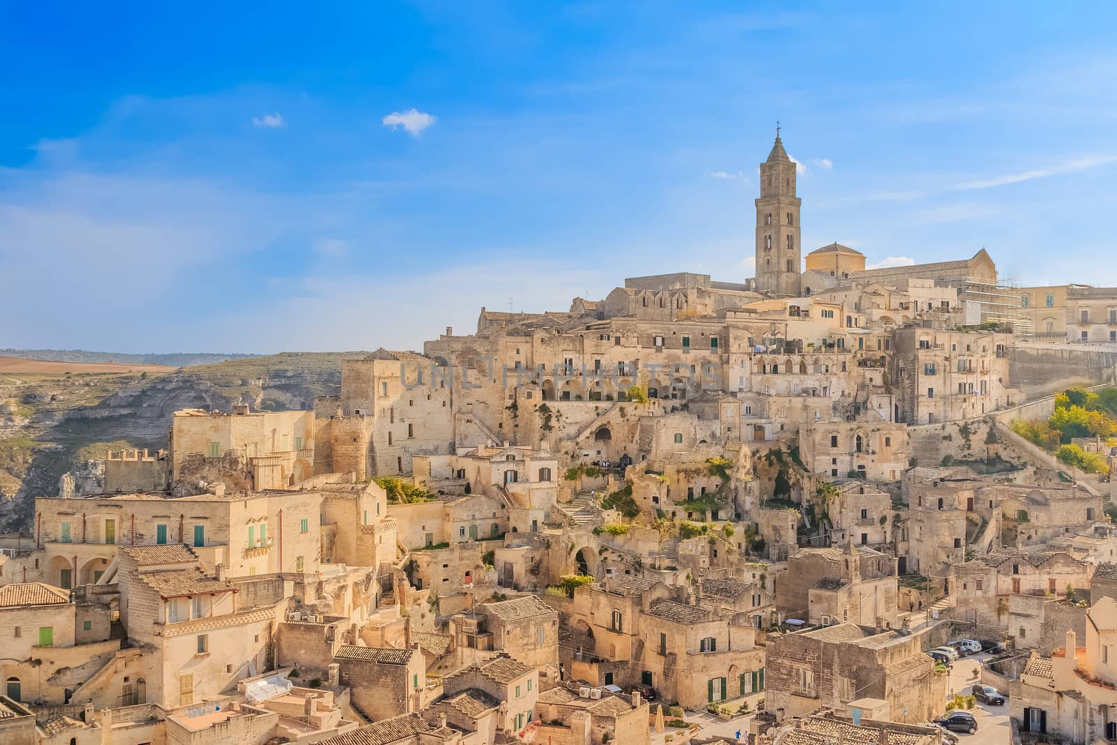 panoramic view of typical stones (Sassi di Matera) and church of Matera UNESCO European Capital of Culture 2019 under blue sky. Basilicata, Italy