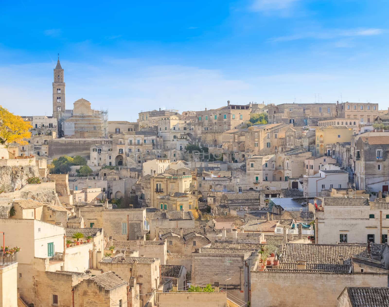 panoramic view of typical stones (Sassi di Matera) and church of Matera under blue sky. Basilicata, Italy