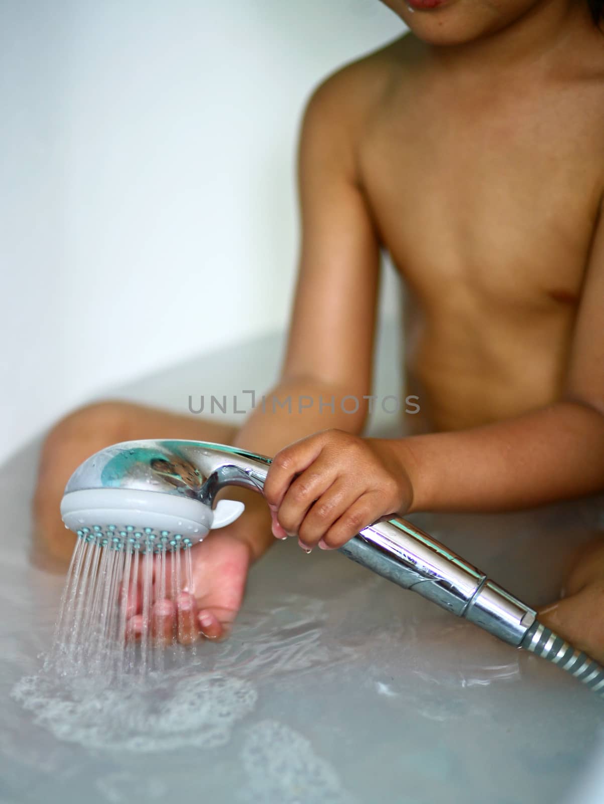 In the bathroom, a child taking a shower