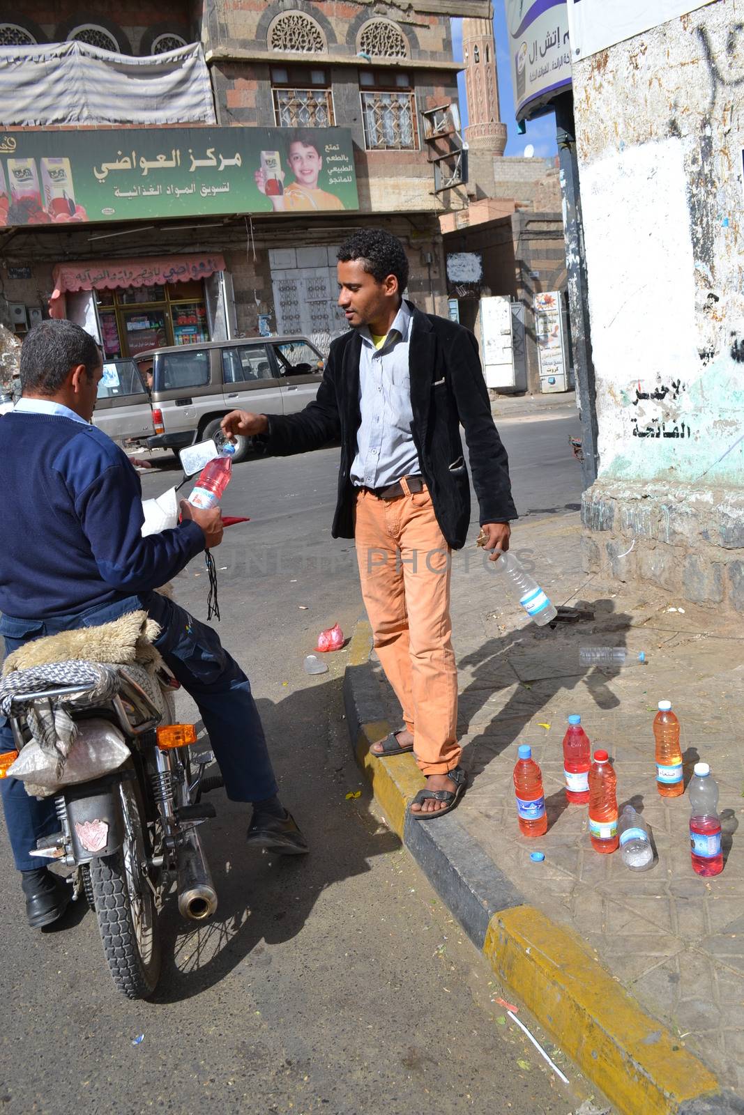 YEMEN, Sanaa: A black market dealer sells bottles of petrol in Sanaa, Yemen's capital, on November 7, 2015, as petrol stations have closed since the beginning of the war and Saudi bombings over the country.