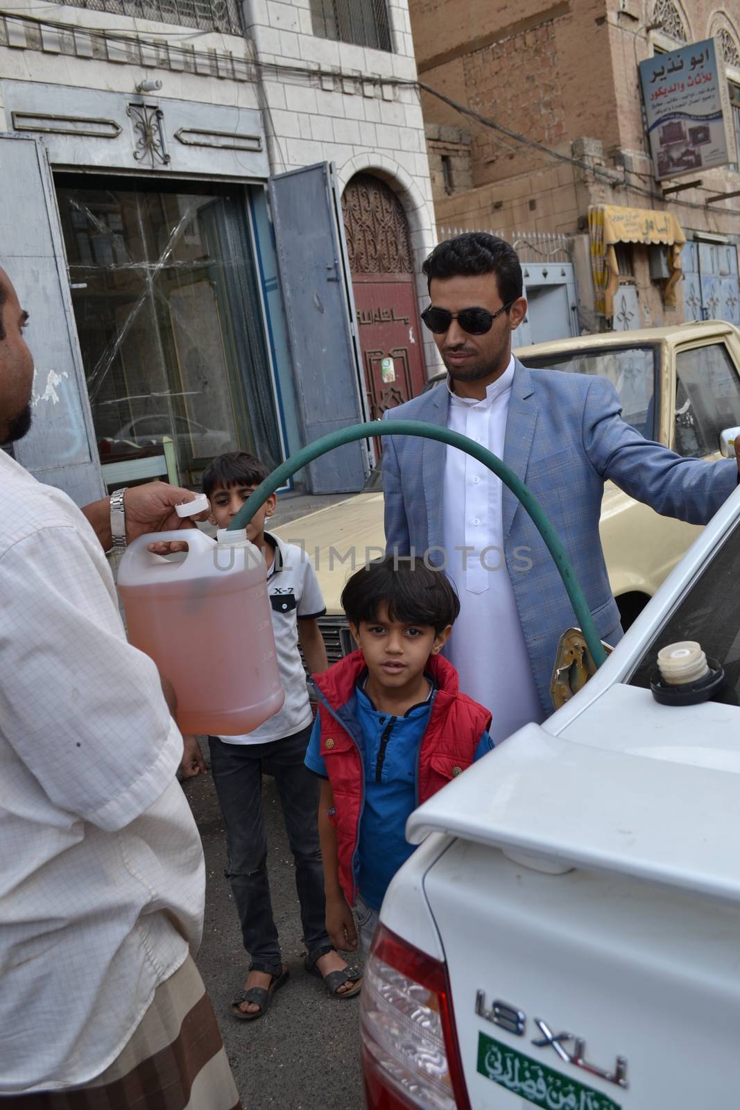 YEMEN, Sanaa: A black market dealer sells bottles of petrol in Sanaa, Yemen's capital, on November 7, 2015, as petrol stations have closed since the beginning of the war and Saudi bombings over the country.