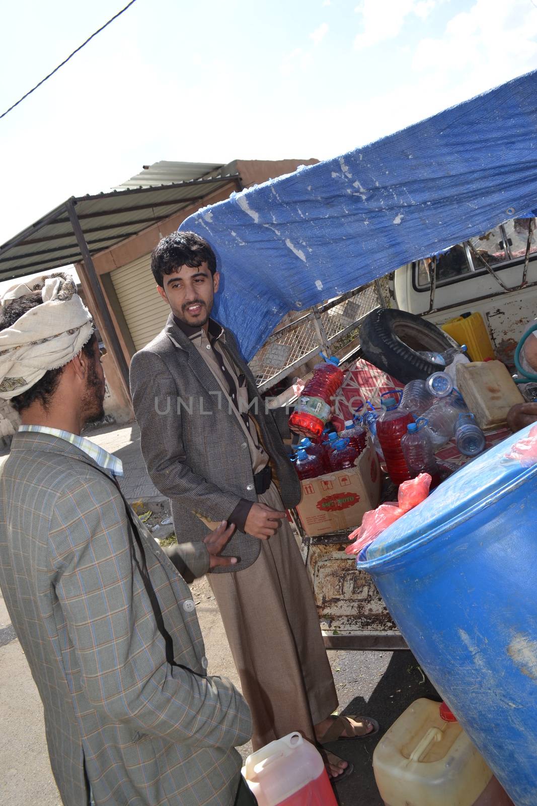 YEMEN, Sanaa: A black market dealer sells bottles of petrol in Sanaa, Yemen's capital, on November 7, 2015, as petrol stations have closed since the beginning of the war and Saudi bombings over the country.