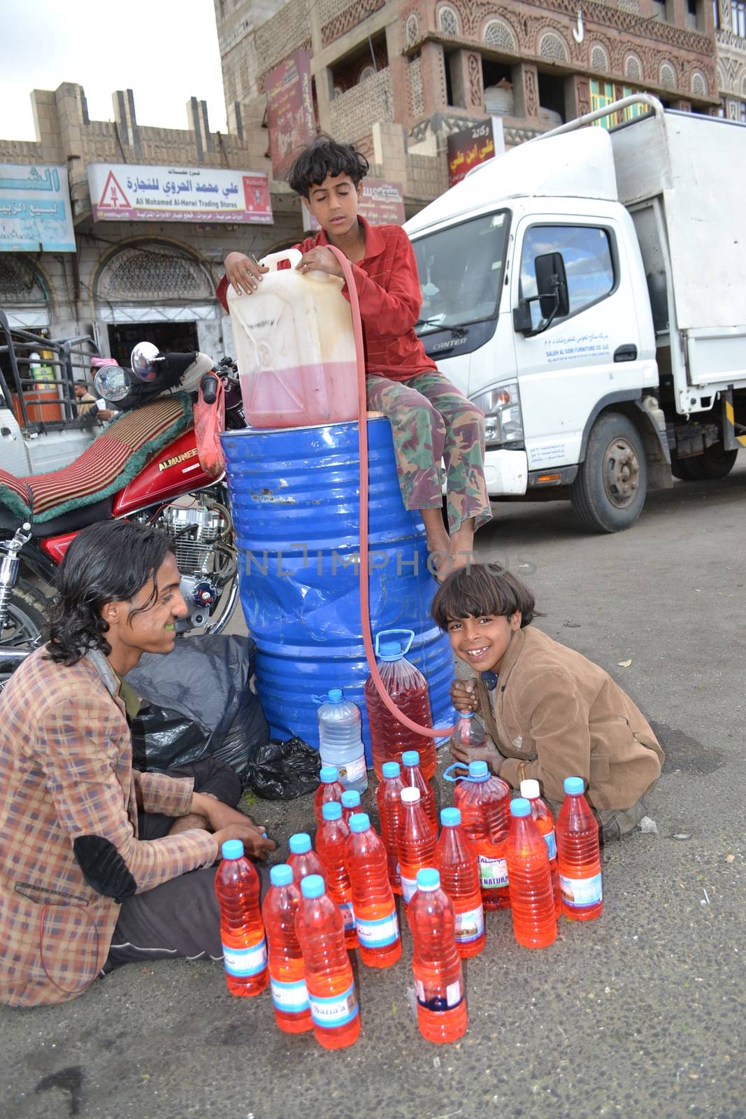 YEMEN, Sanaa: Black market dealers sell bottles of petrol in Sanaa, Yemen's capital, on November 7, 2015, as petrol stations have closed since the beginning of the war and Saudi bombings over the country.