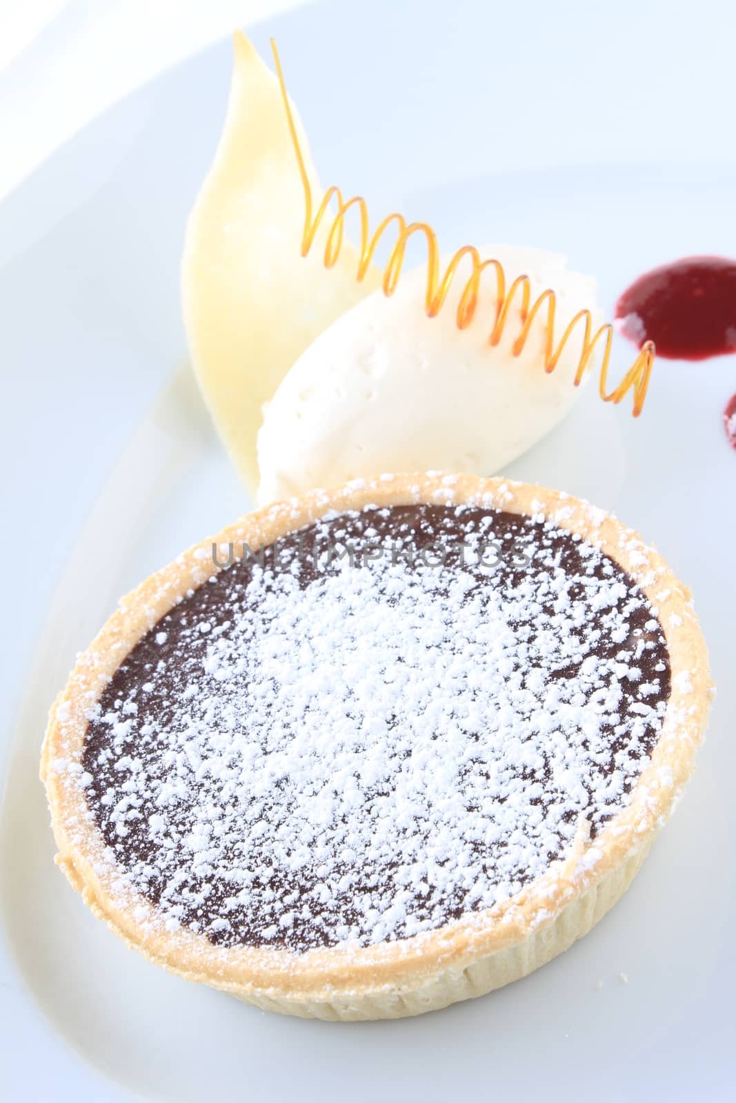 chocolate tart dessert with coulis