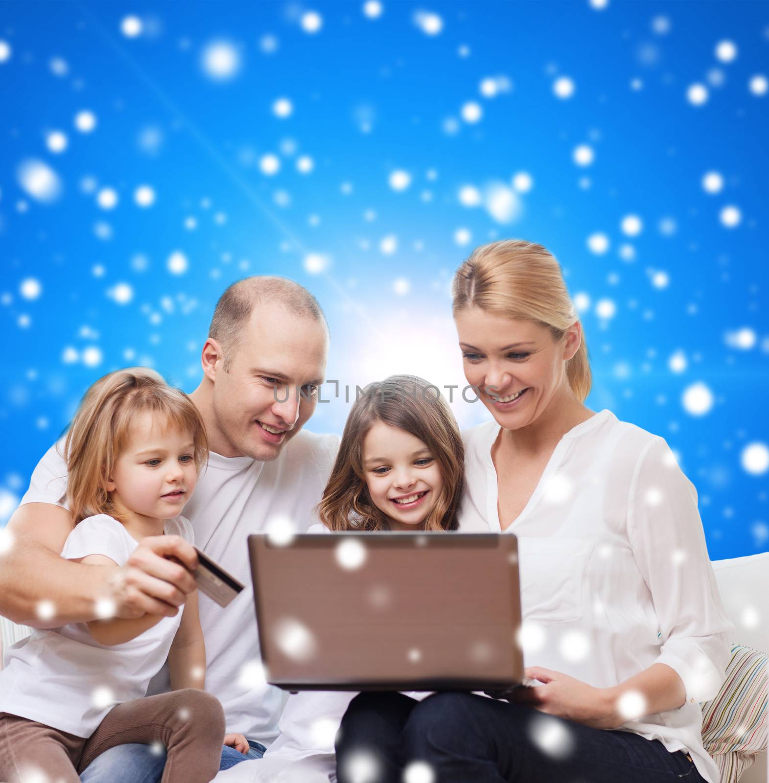 happy family with laptop computer and credit card by dolgachov