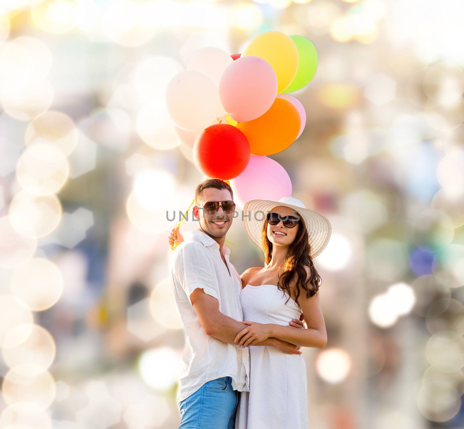 smiling couple with air balloons outdoors by dolgachov