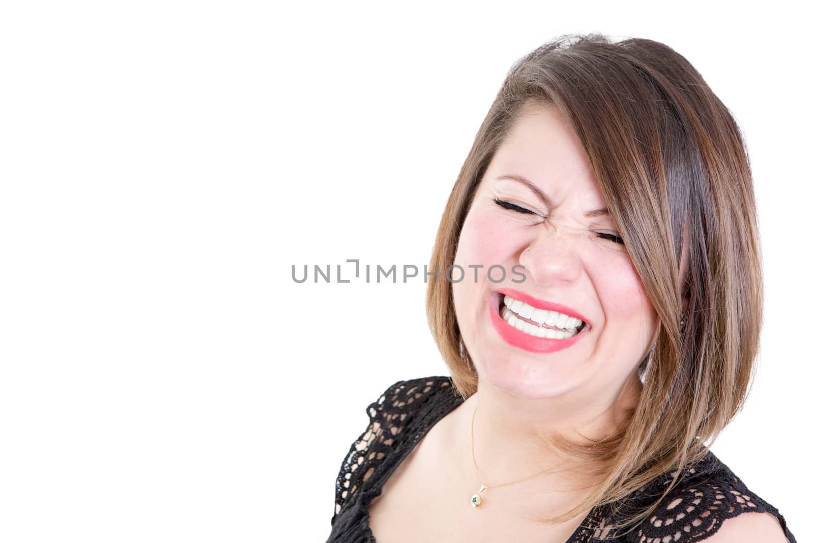 Close up Very Happy Woman Showing a Toothy Smile with Eyes Closed Against White Background with Copy Space on the Left.