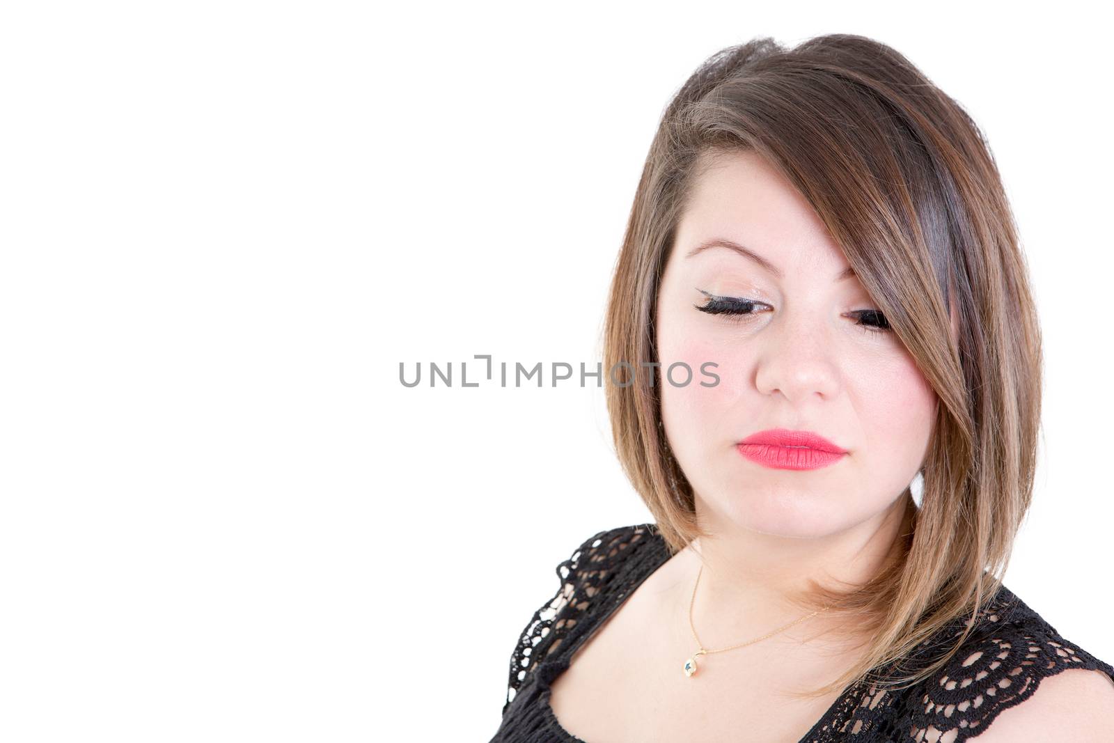 Close up Thoughtful Young Woman Looking Down Against White Background with Copy Space on the Left Side.