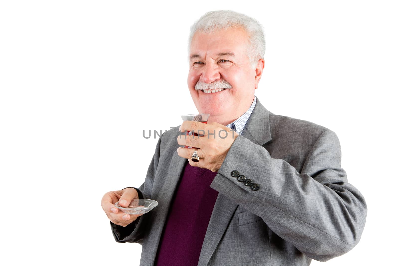 Half Body Shot of a Smiling Middle Aged Businessman, Holding a Turkish Tea While Looking Out Against White Background.