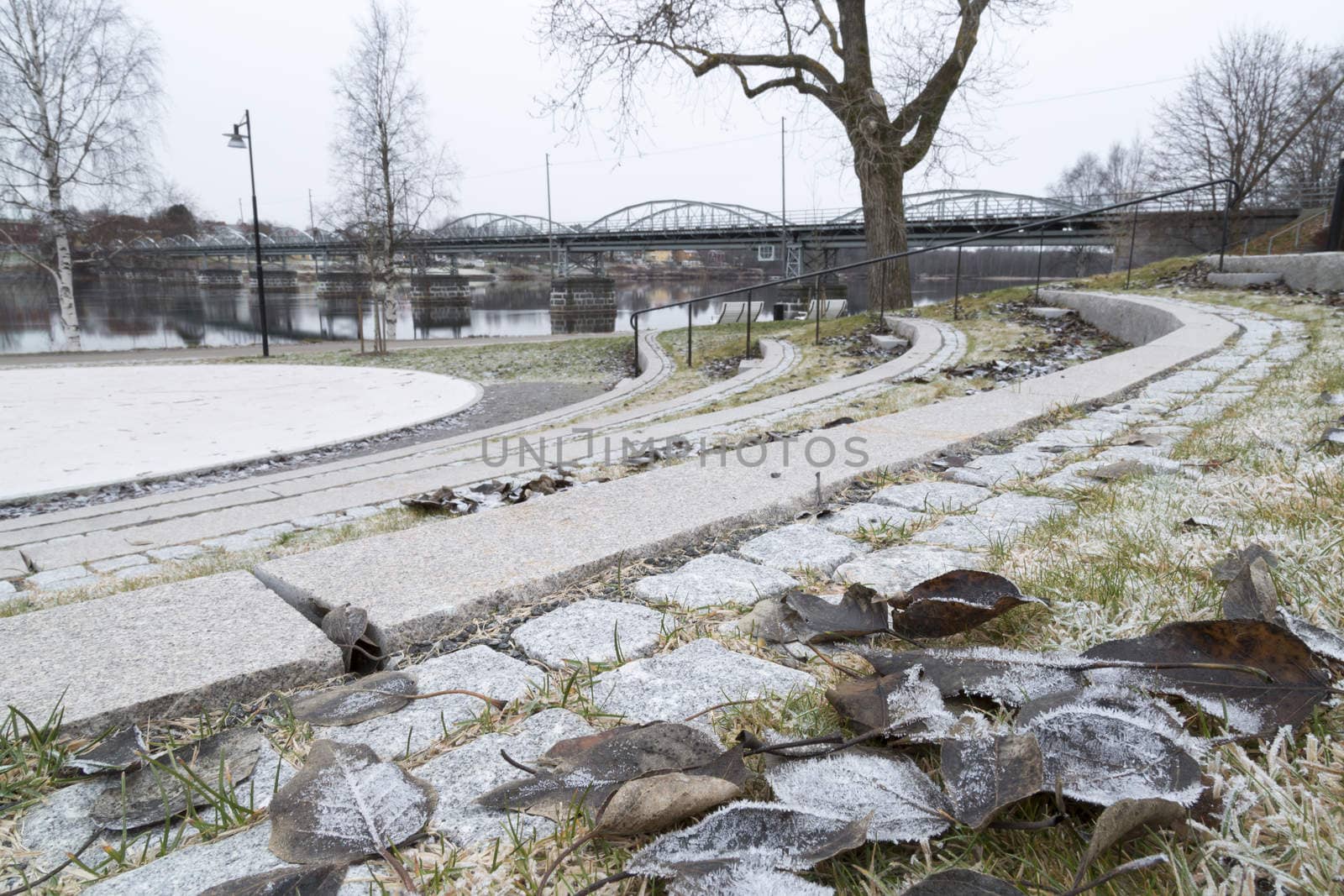 Bridge in Umeå, Sweden with leaves and river.