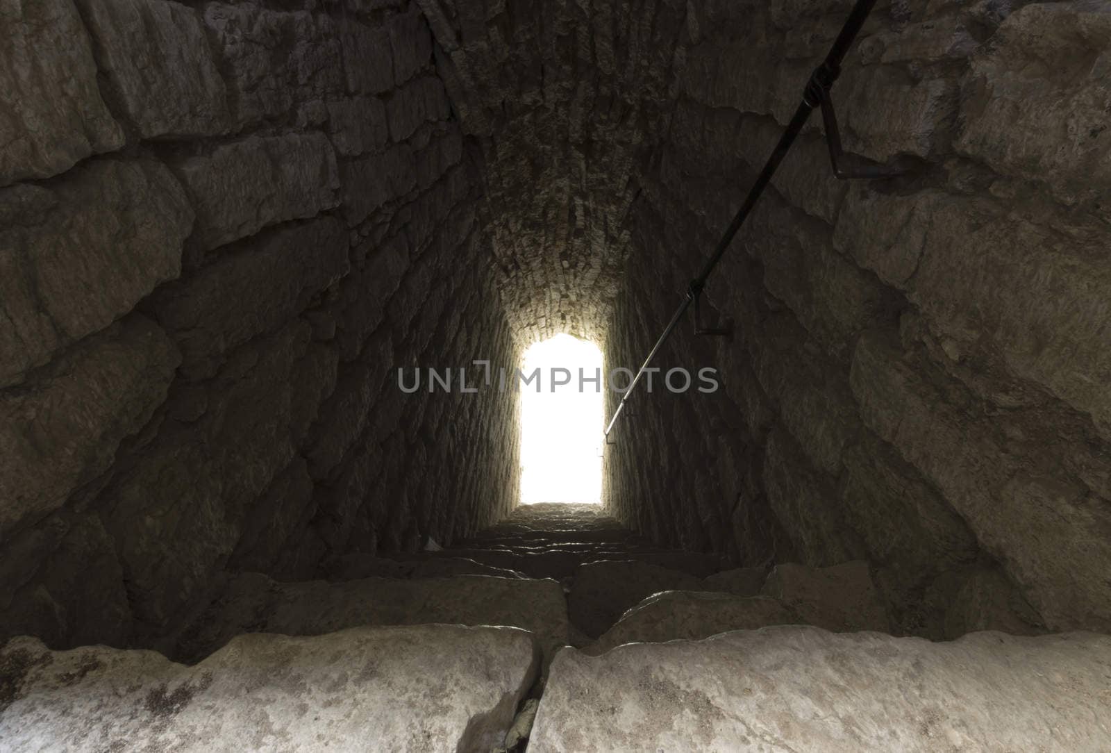 Staircase Leading Into Light with rocks all around.