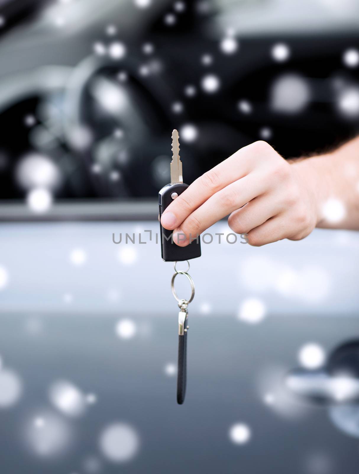 close up of man with car key outdoors by dolgachov