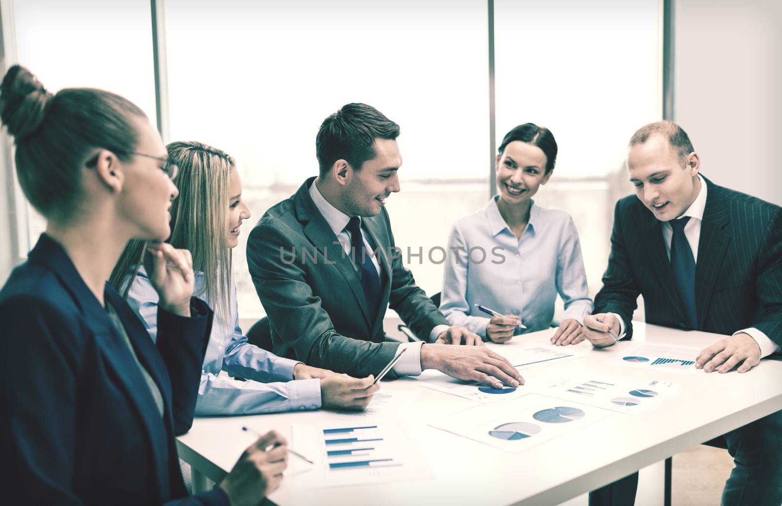 smiling business team at meeting by dolgachov