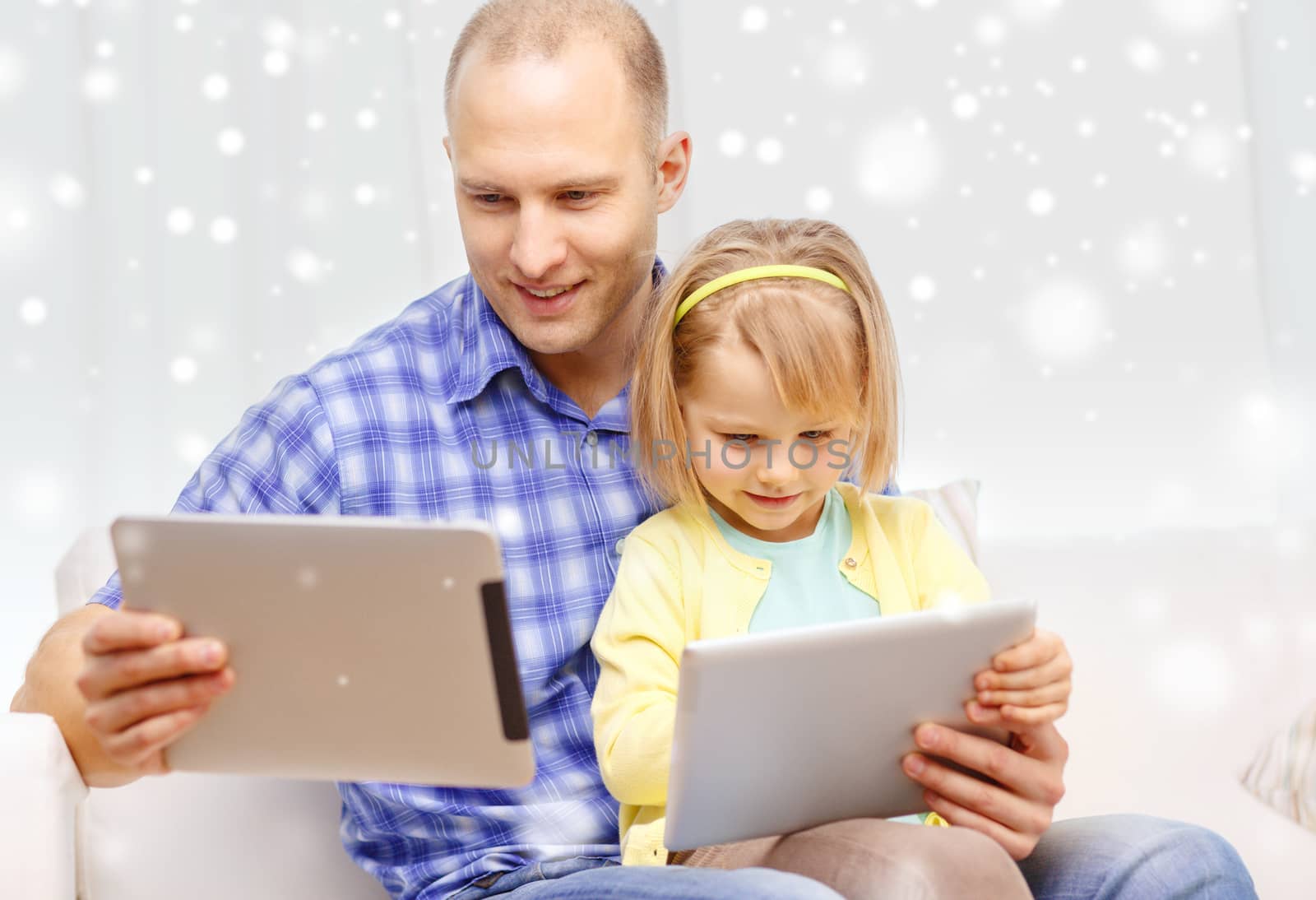 family, children, technology and people concept - happy father and daughter with tablet pc computers at home