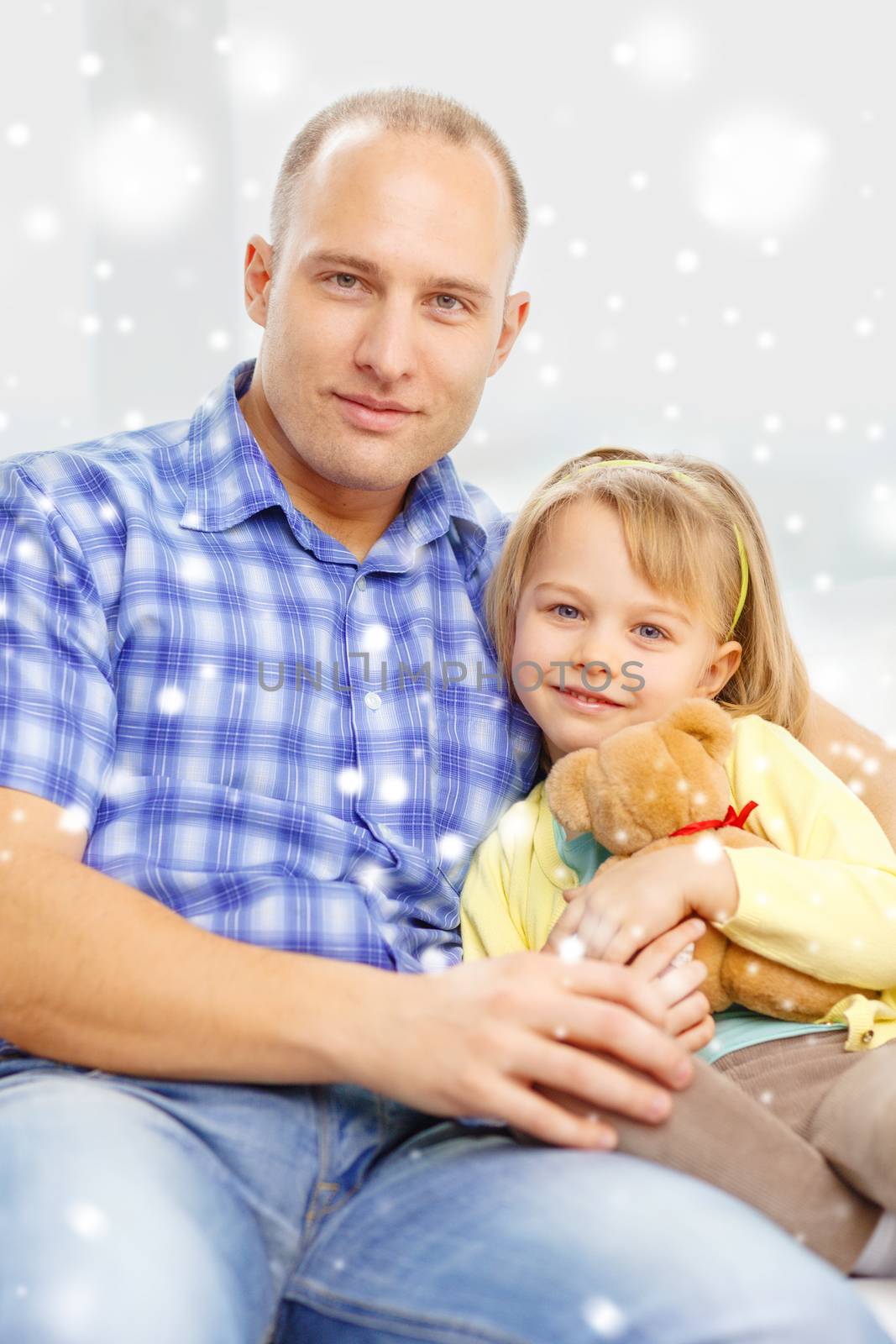 family, child and happiness concept - smiling father and daughter with teddy bear toy at home