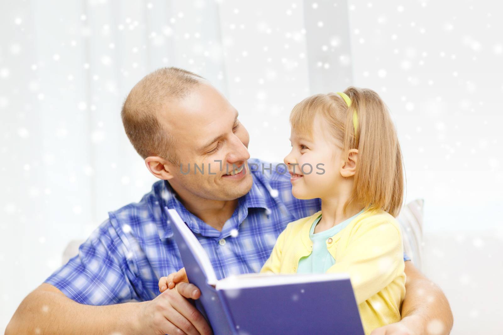 smiling father and daughter with book at home by dolgachov